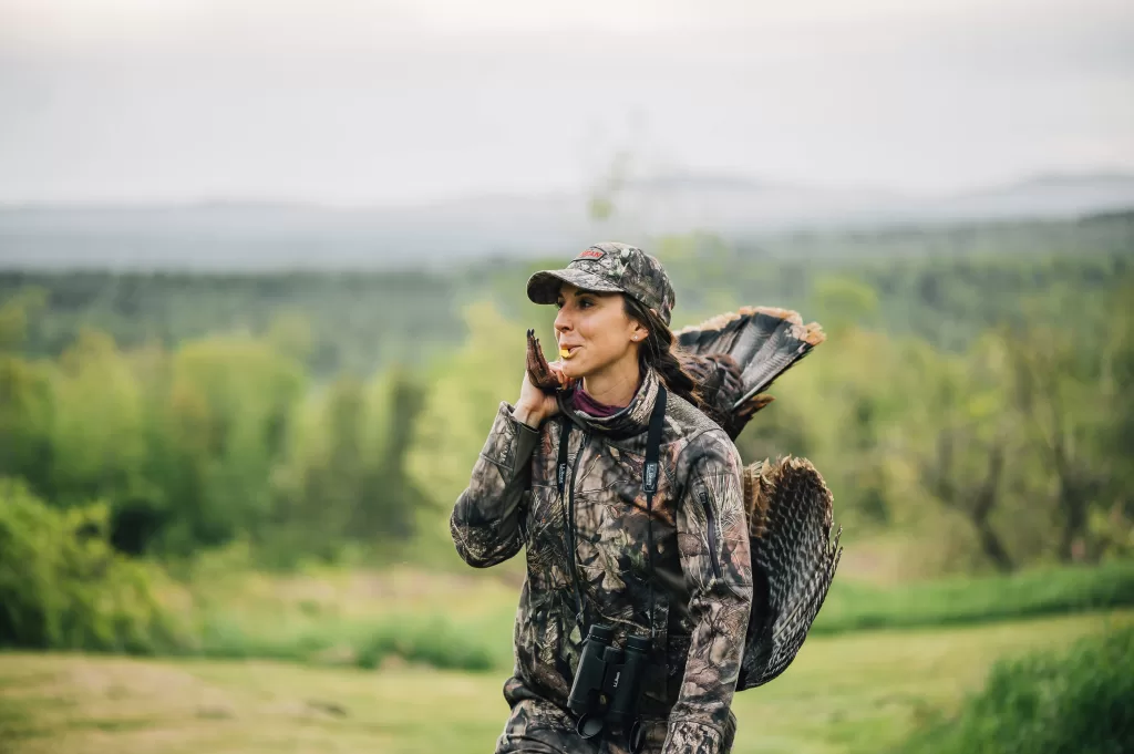 A hunter carrying a turkey