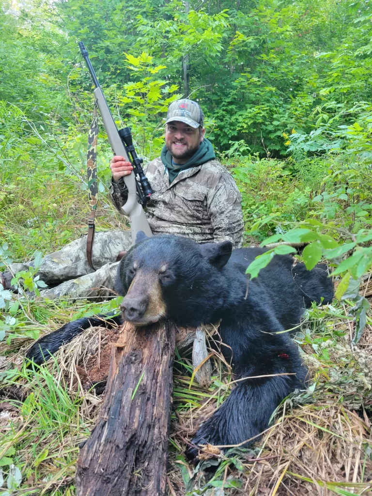 hunter posing after a successful bear hunt