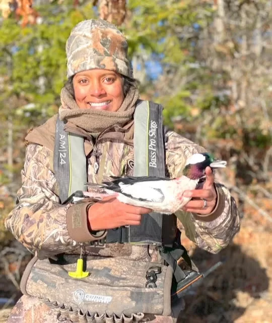 hunter posing with duck after a successful hunt