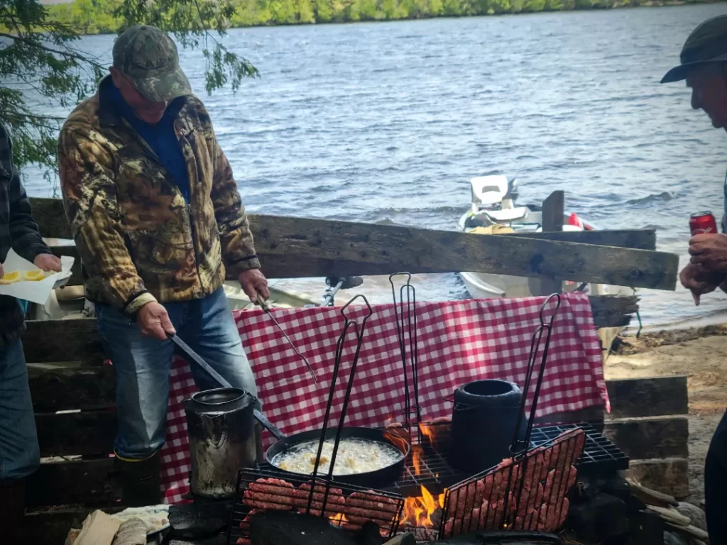 cooking at a campsite by the river